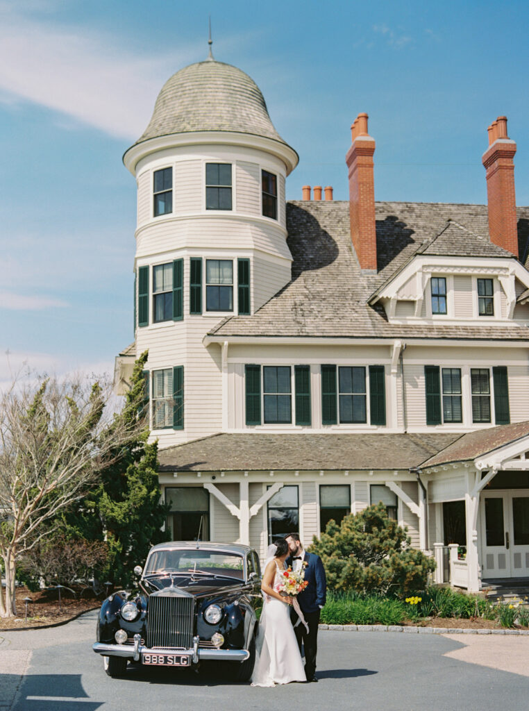 Bride and groom with a vintage Rolls-Royce outside Castle Hill Inn in Newport, Rhode Island, photographed by Schwalbs Photography, a Newport wedding photographer.
